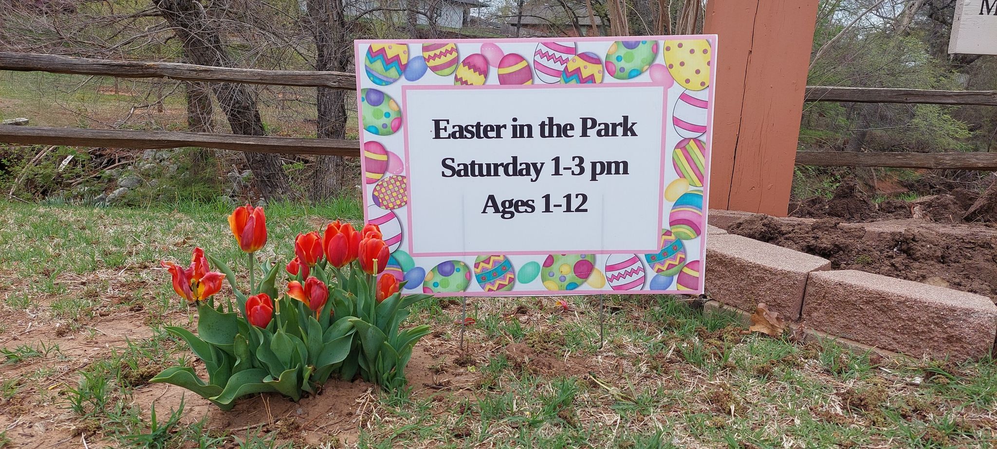 Tulips and a sign. Easter in the park. Saturday 1-3 pm. Ages 1-12.