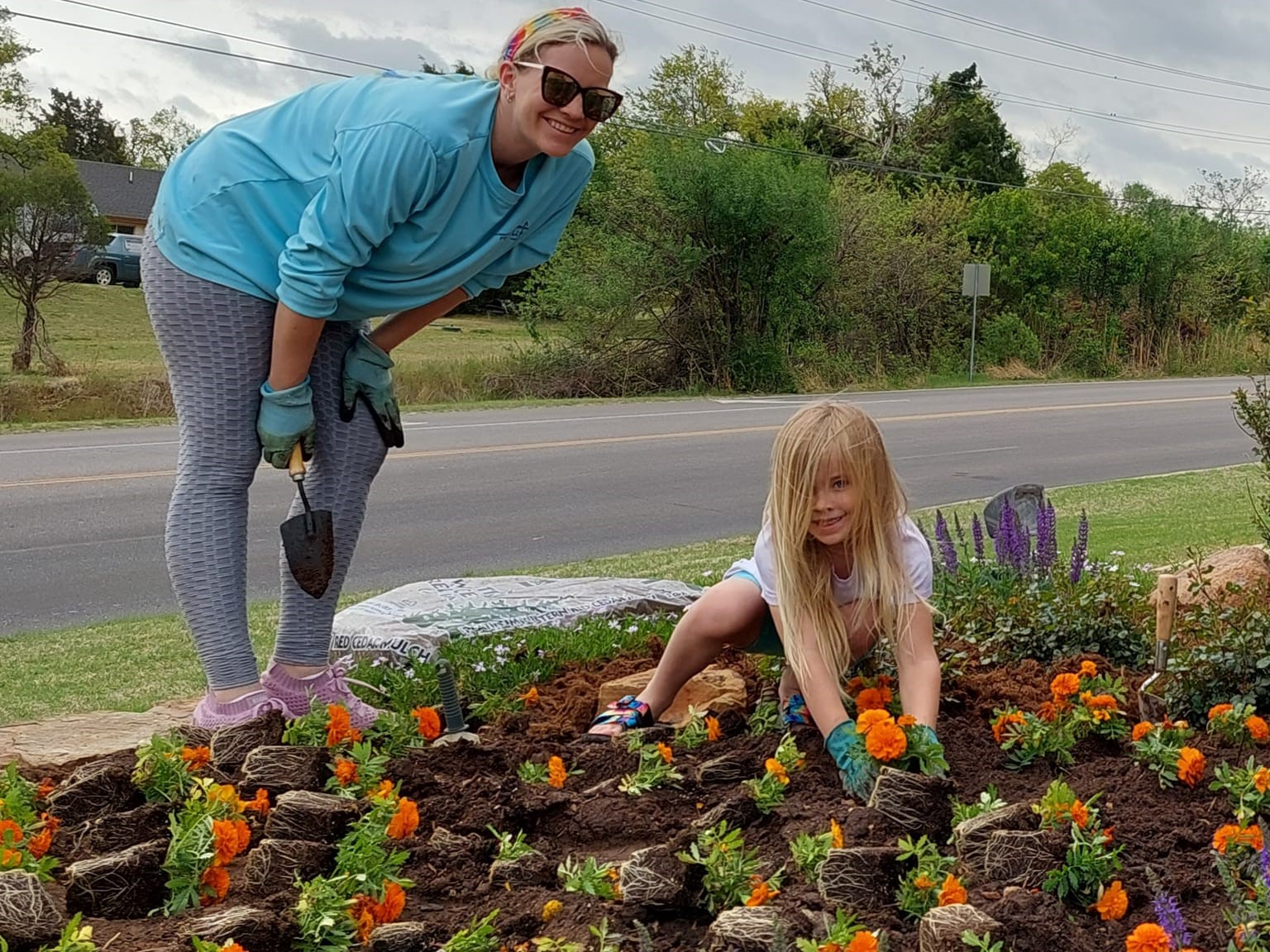 mother and daughter planting flowers